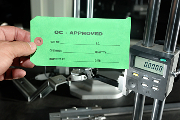 Quality-control approved tag on an inspected part
